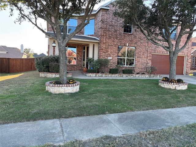 view of front of home featuring a garage and a front yard