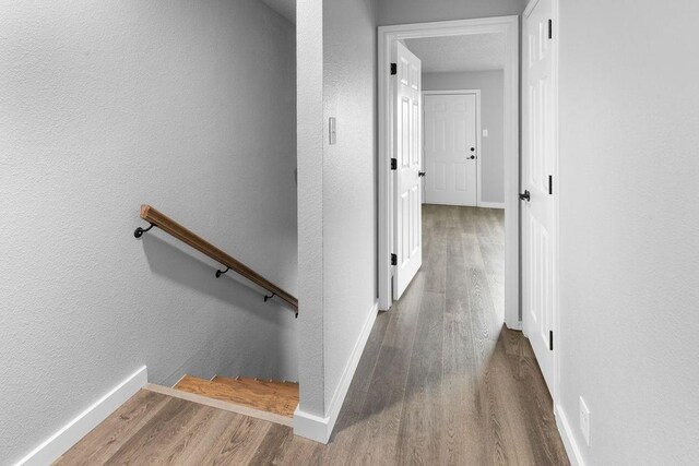 corridor with hardwood / wood-style floors