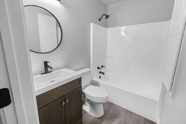 full bathroom featuring vanity, wood-type flooring, shower / washtub combination, and toilet