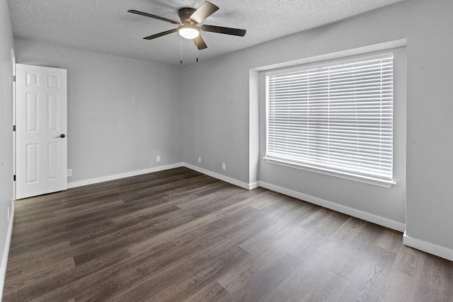 spare room with ceiling fan, dark hardwood / wood-style floors, and a textured ceiling