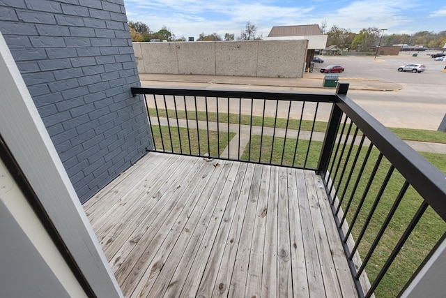 wooden terrace with a lawn