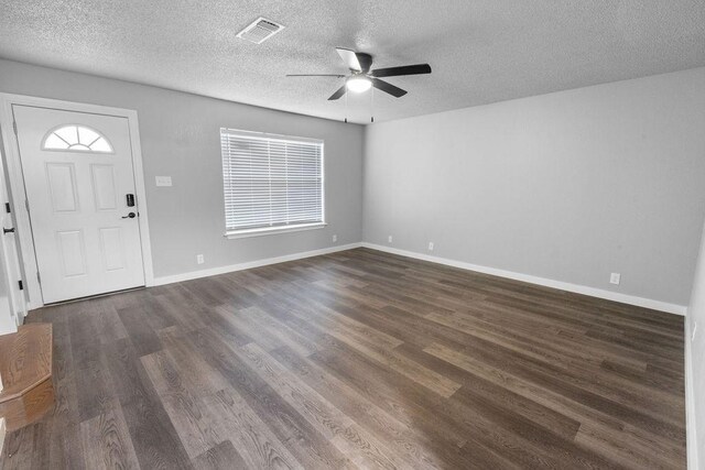 entrance foyer featuring ceiling fan, dark hardwood / wood-style floors, and a textured ceiling