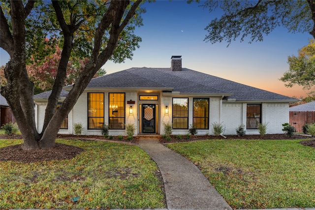 view of front of home with a yard