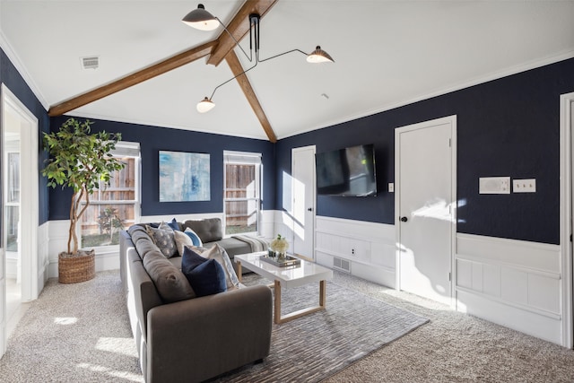 living room featuring vaulted ceiling with beams, carpet, and ornamental molding