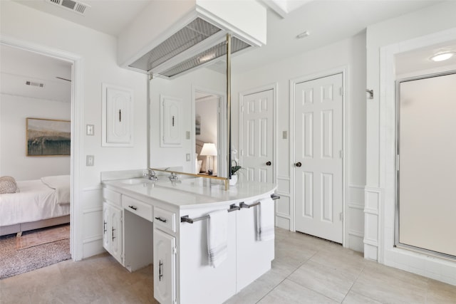 bathroom with tile patterned floors, vanity, and a shower with shower door