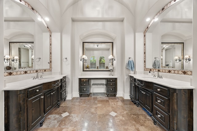 bathroom with vanity and lofted ceiling