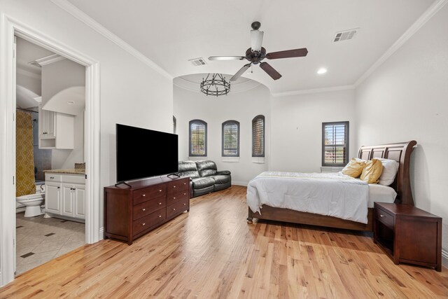 bedroom featuring light hardwood / wood-style flooring, ensuite bath, crown molding, and ceiling fan