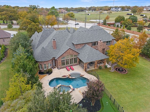 view of swimming pool featuring a lawn and a patio