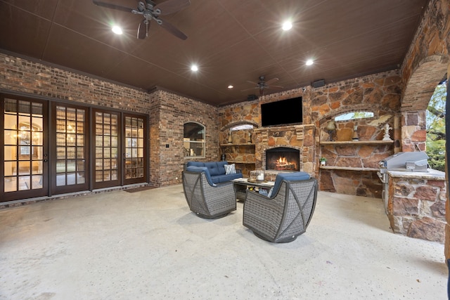 view of patio with an outdoor living space with a fireplace, area for grilling, and ceiling fan