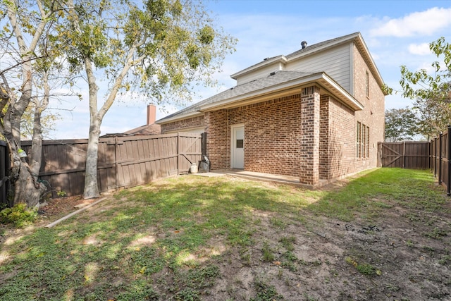 rear view of house with a yard