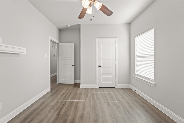 unfurnished bedroom featuring ceiling fan and light wood-type flooring