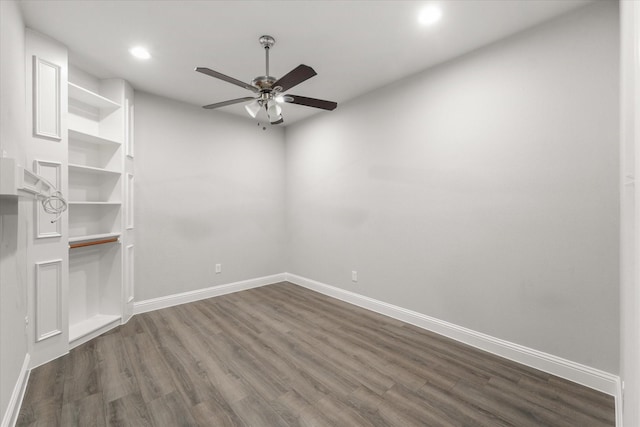 unfurnished room featuring dark wood-type flooring and ceiling fan