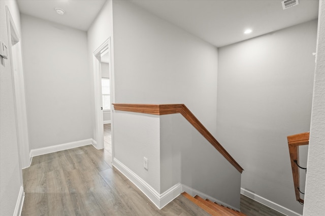 hallway with light hardwood / wood-style floors