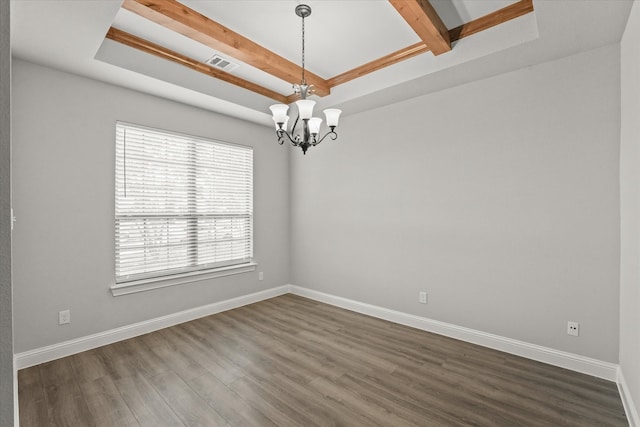 spare room featuring dark hardwood / wood-style floors, a tray ceiling, beam ceiling, and a notable chandelier