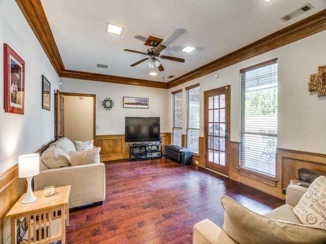 living room featuring a textured ceiling, dark hardwood / wood-style floors, ceiling fan, and ornamental molding