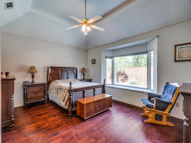 bedroom with a textured ceiling, ceiling fan, lofted ceiling, and dark wood-type flooring