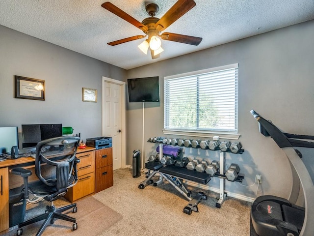 carpeted home office featuring ceiling fan and a textured ceiling