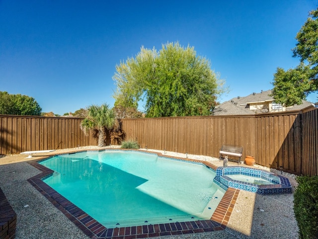 view of pool featuring an in ground hot tub