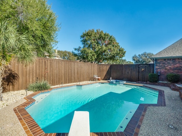 view of pool with a diving board