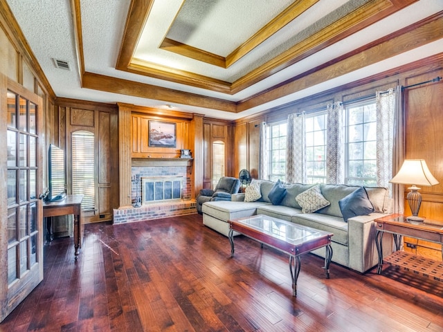 living room featuring a textured ceiling, wood-type flooring, crown molding, and wooden walls