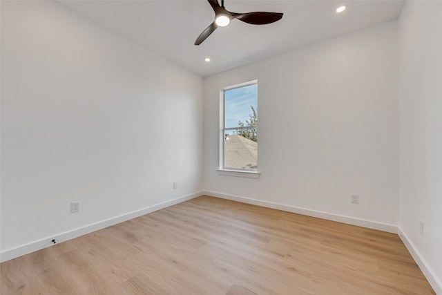 spare room featuring light wood-type flooring and ceiling fan