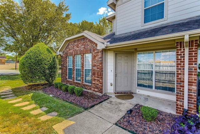 doorway to property with a lawn