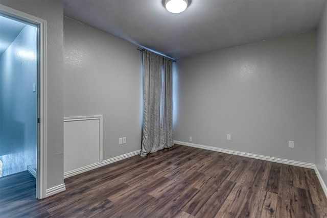 spare room with dark hardwood / wood-style floors