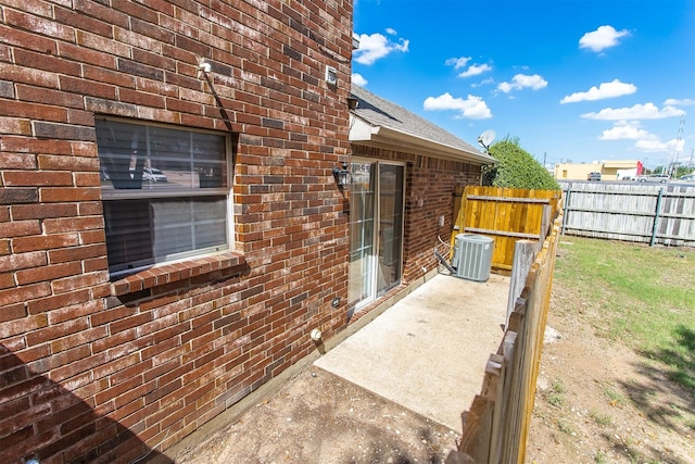 exterior space with cooling unit and a patio