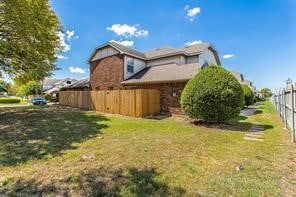 view of side of home featuring a yard