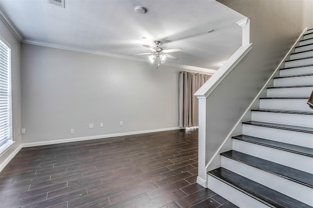 interior space with ornamental molding, dark wood-type flooring, ceiling fan, and a healthy amount of sunlight