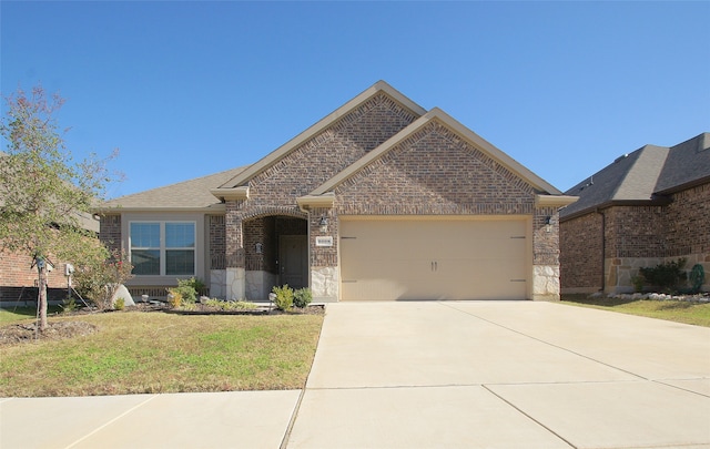 view of front of home with a garage and a front lawn