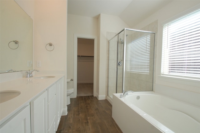 full bathroom with vanity, toilet, plus walk in shower, and hardwood / wood-style flooring