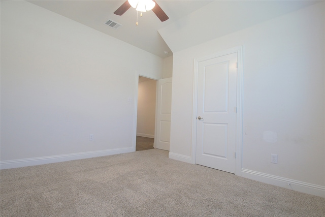 unfurnished bedroom with ceiling fan, carpet, and vaulted ceiling