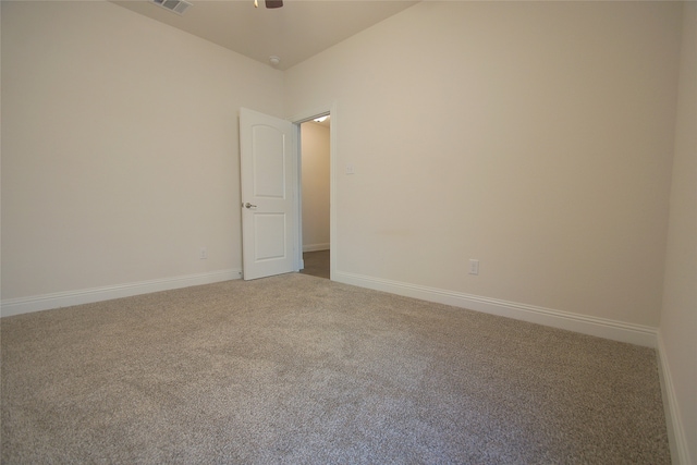 empty room featuring carpet flooring and ceiling fan