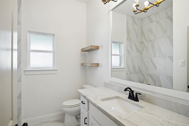 bathroom featuring vanity, a chandelier, and toilet