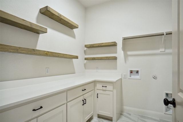 clothes washing area featuring cabinets and washer hookup