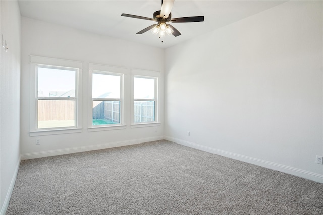 unfurnished room with ceiling fan and carpet flooring