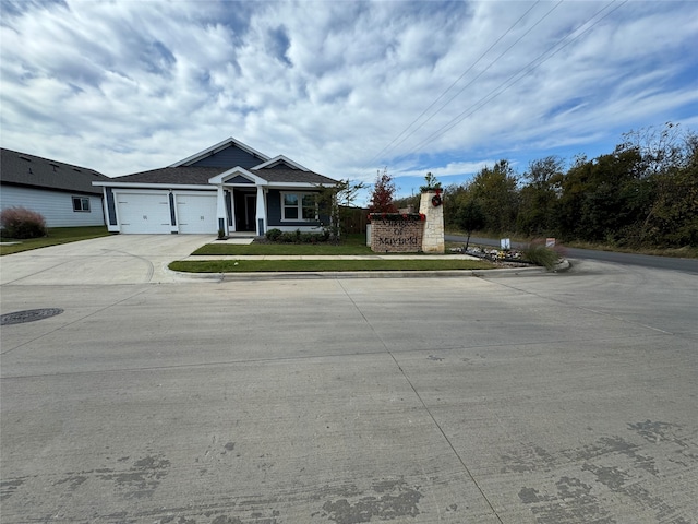 view of front of home featuring a front yard and a garage