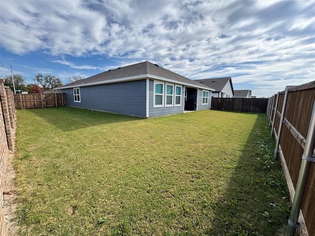 back of property featuring a lawn