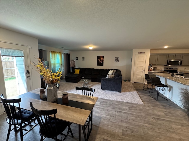 dining area with dark hardwood / wood-style flooring and a textured ceiling