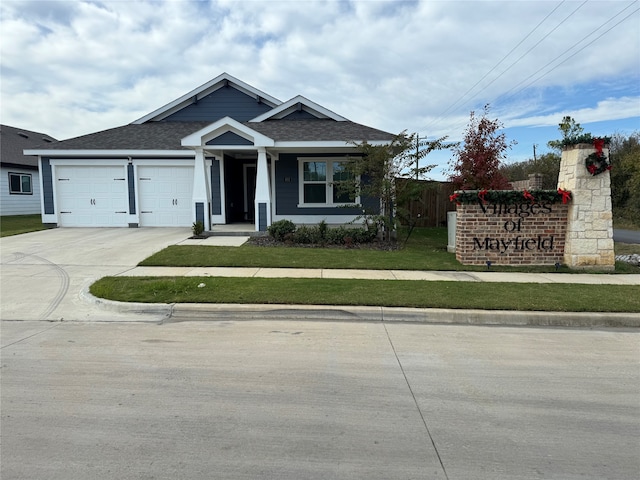 view of front of home featuring a front yard and a garage