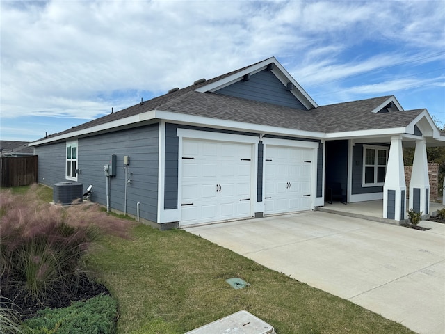 view of home's exterior with cooling unit and a garage