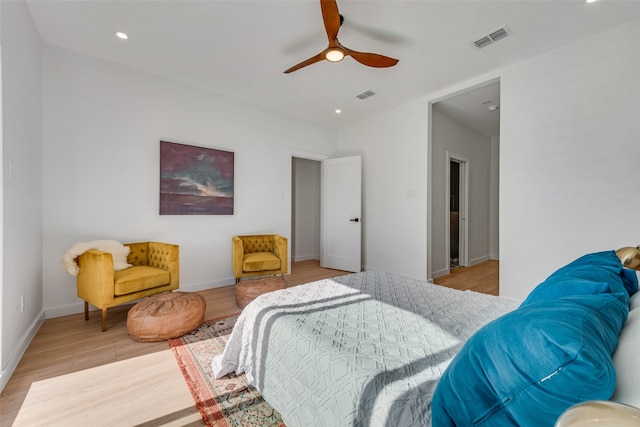 bedroom with light hardwood / wood-style floors and ceiling fan