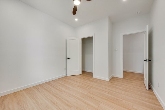 unfurnished bedroom with a closet, light hardwood / wood-style flooring, and ceiling fan