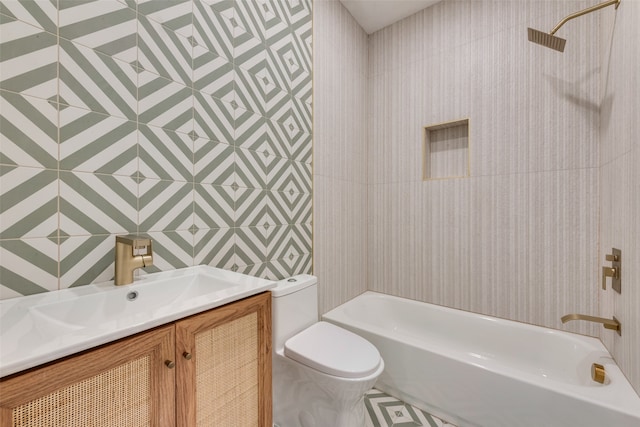 full bathroom featuring shower / washtub combination, vanity, tile walls, and toilet