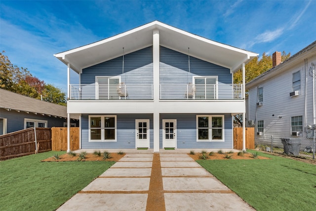 contemporary home featuring a balcony, a front lawn, and cooling unit