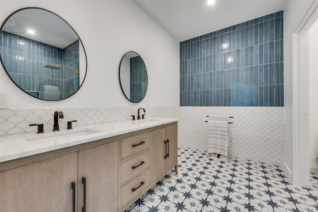 bathroom with vanity and tile walls