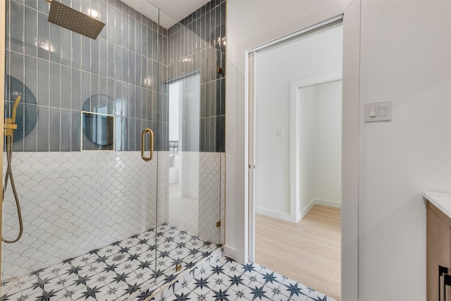 bathroom with walk in shower and hardwood / wood-style flooring