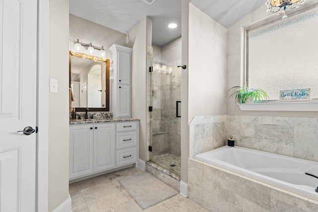 bathroom with vanity and shower with separate bathtub