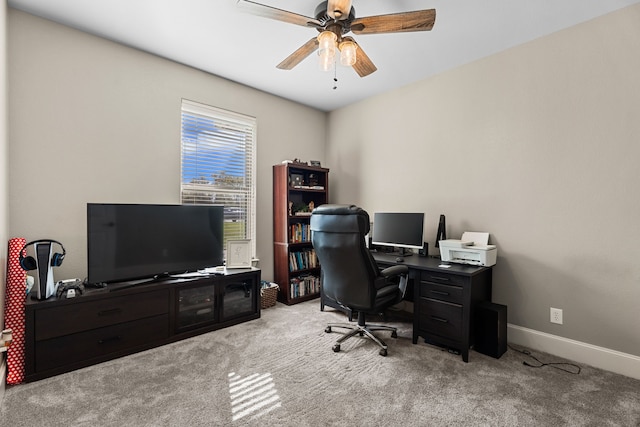 carpeted office space with ceiling fan